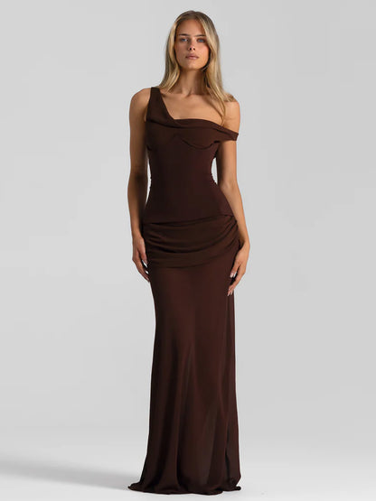 Woman wearing a brown one-shoulder evening gown on a gray background